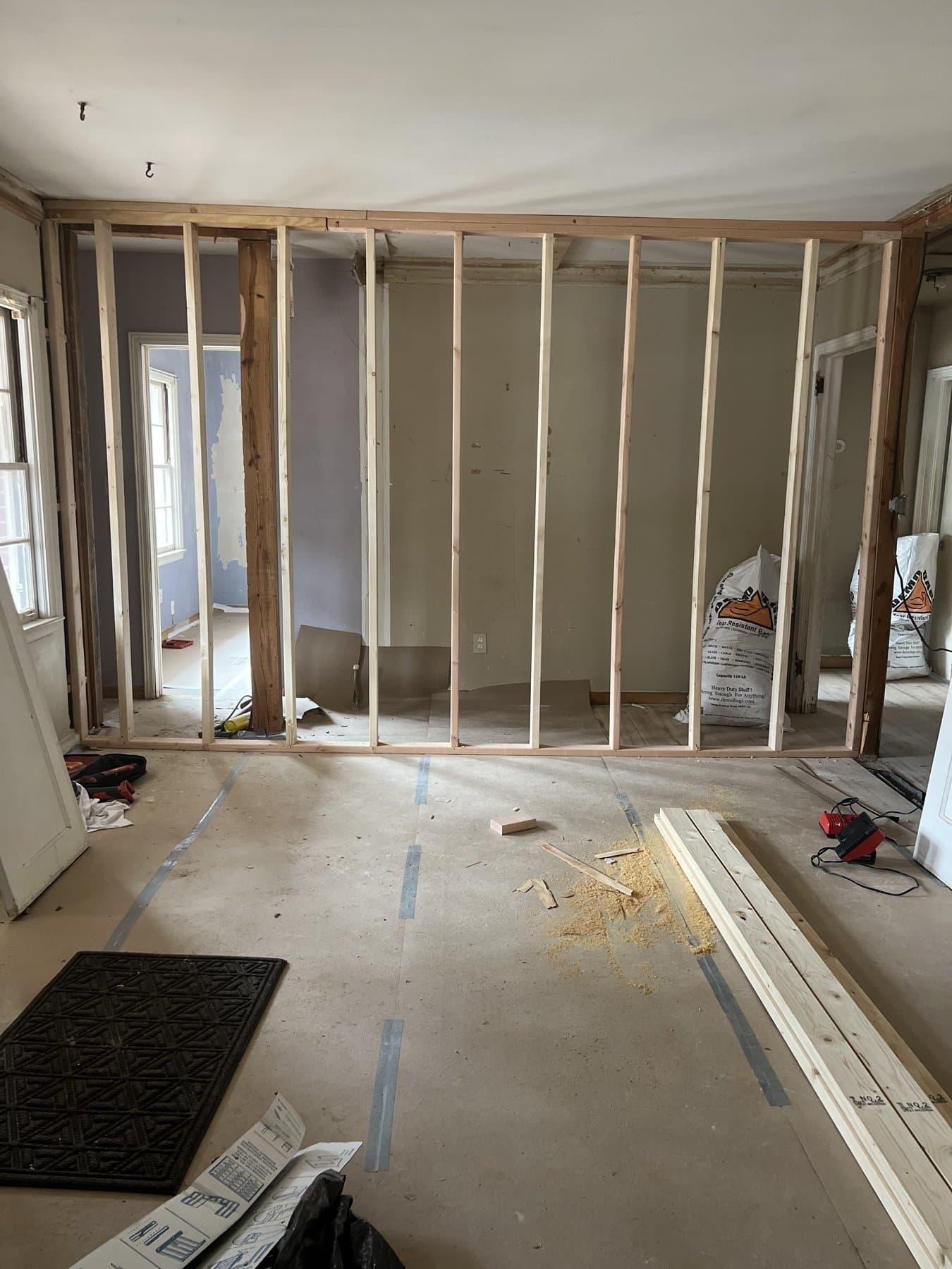 A wall opened to the studs during one of Evan's renovations